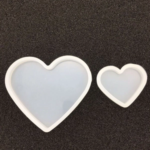 Macro detail of large and small heart shaped silicone molds for DIY resin casting projects