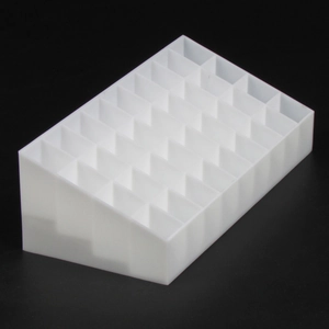 Close-up of white plastic lipstick organizer with slanted multi-grid storage design