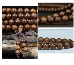 Macro detail of 108 sandalwood prayer beads showing smooth grain and handcrafted knots