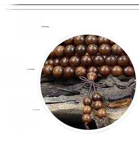 Macro detail of polished dark sandalwood prayer beads with natural wood grain texture