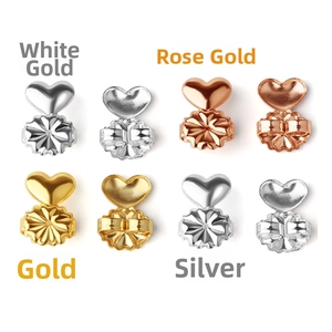 Macro display of heart-shaped earring lifters in gold, silver, and rose gold finishes