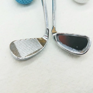 Macro shot of silver alloy golf club heads with polished finish and anti-slip textures