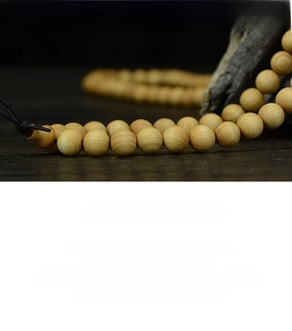Macro shot of high-oil Thuja Sutchuenensis wood beads showing natural growth rings