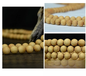 Detailed macro view of 108 polished natural cedar wood beads with fine grain texture