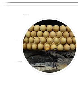 Close-up of polished natural wood beads showing circular grain and smooth round texture