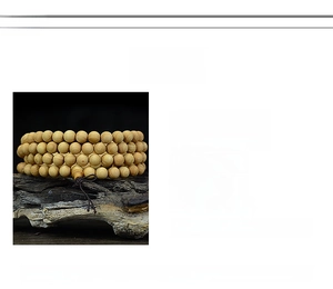 Detailed view of high-oil Thuja wood beads with natural grain for Buddhist meditation