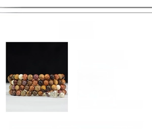 Detailed view of 108 redwood prayer beads bracelet with diverse wood textures and charms