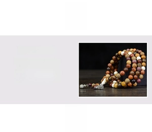 Detail of multicolored wooden 108 prayer beads bracelet with natural wood grain texture
