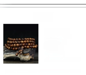 Detail of 108 black rosewood prayer beads featuring natural grain and a traditional tassel