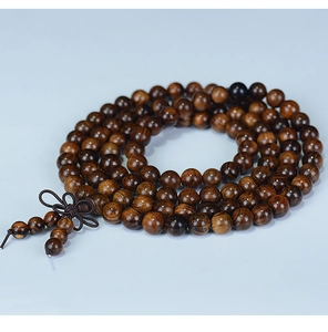 Macro shot of 108 dark brown rosewood beads with a traditional hand-woven Chinese knot