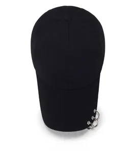 Top view of black cotton baseball cap showing six-panel crown and silver metal rings on brim