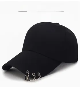 Detail of black cotton baseball cap featuring three silver metal rings on the curved brim