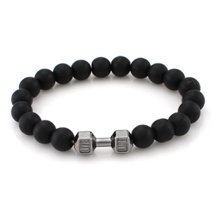 Macro detail of black matte volcanic stone beads and silver dumbbell charm with LIVE engraving