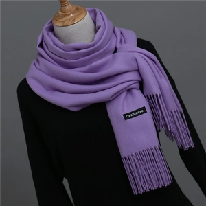 Detail of soft purple cashmere scarf with elegant fringe texture on a display mannequin