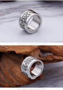 Macro view of wide silver skull ring with Living But Only punk style engraving