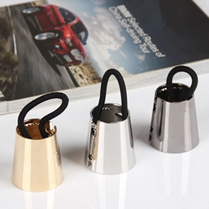Three conical metal ponytail cuffs in gold, silver, and gunmetal with black hair ties
