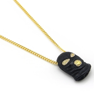 Detail of hip hop cuban chain with black ski mask pendant and inlaid rhinestones
