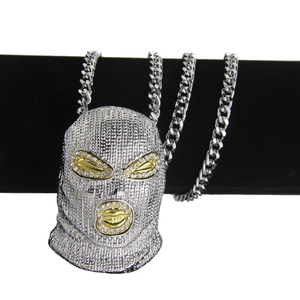 Detailed view of silver pavé crystal ski mask pendant on a thick cuban chain