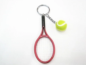 Detailed top view of a red metal tennis racket keychain with a yellow mini ball charm