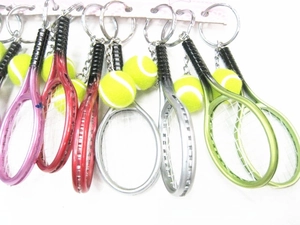 Detailed close-up of mini tennis racket and ball keychains in multiple vibrant colors