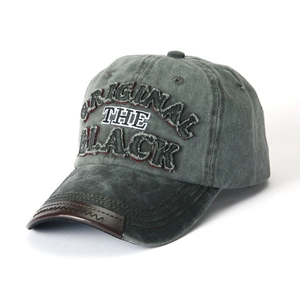 Detail of vintage charcoal cotton baseball cap with 3D embroidery and leather brim accent