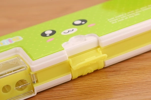 Close-up of integrated dual-hole sharpener and spring switch on a cartoon pencil case