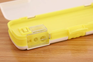 Close-up of integrated dual pencil sharpener inside a cartoon plastic stationery case