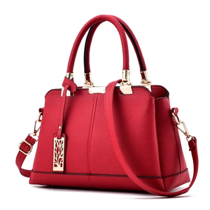 Elegant red litchi leather handbag for women with golden hardware and leaf charm