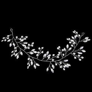Detail of bridal hairband with white pearls and marquise-cut crystals on silver wire
