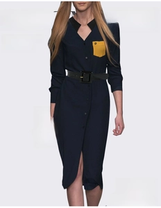 Detail of a navy shirt dress featuring a black square buckle waist belt and contrast pocket