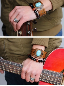 Detail of vintage leather wristband with turquoise stone and beads while playing guitar