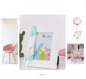 Detail of white photo frame with 3D resin rabbit and balloon relief for 4x6 inch images
