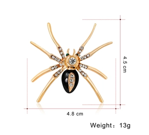 Detailed view of gold spider brooch size 4.5cm by 4.8cm with white and green crystals