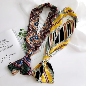 Elegant silk scarves with geometric and animal prints displayed on a minimalist background