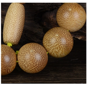 Macro shot of high-density dragon blood bamboo beads showing natural scale patterns