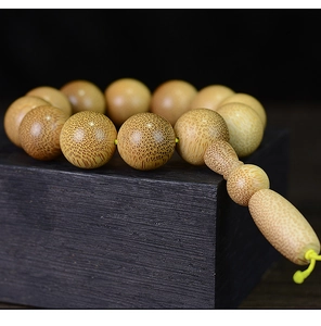 Macro detail of natural dragon blood bamboo beads showing fibrous texture and zen aesthetic