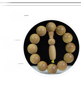 Detailed view of round Dragon Blood bamboo beads with natural speckled texture and tassel