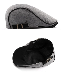Detail showing grey textured ivy cap with black trim, metal buckle, and breathable lining
