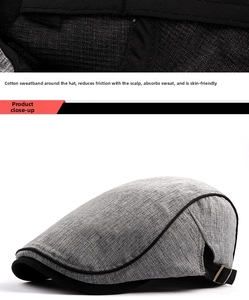 Detail of grey cotton beret featuring a metallic buckle and breathable inner sweatband