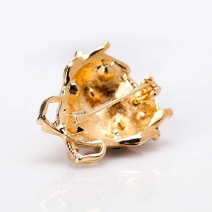 Golden ladybug brooch back view with safety pin and textured alloy finish
