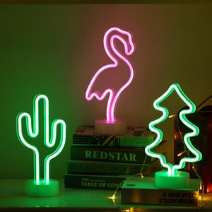 Three LED neon lights featuring green cactus, pink flamingo, and Christmas tree shapes on white bases