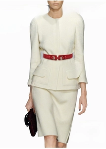 Detail of red thin waist belt paired with minimalist cream-colored blazer dress set