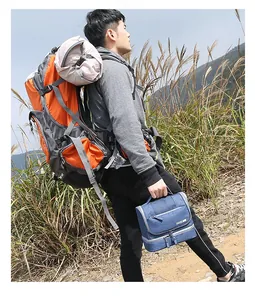 Blue multi-layer travel toiletry bag with zipper and handle shown in outdoor setting