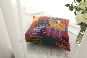 Detailed view of colorful bohemian patchwork patterns on a cotton linen cushion cover