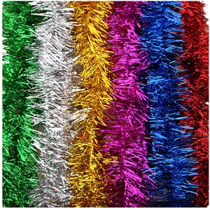 Macro detail of multi-colored tinsel garlands in green, gold, blue and red finishes