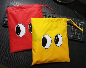 Waterproof drawstring storage bag with cartoon eye prints in red and yellow colors
