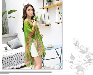 Detail of bohemian floral chiffon shawl with light green prints and pearl embellishments