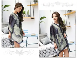 Detail of bohemian chiffon sun shawl with intricate paisley prints and irregular hem