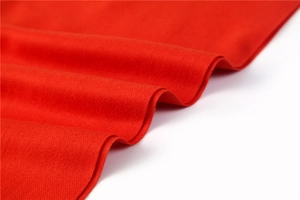 Detailed macro shot of high-quality bright red cashmere-like fabric texture and drape