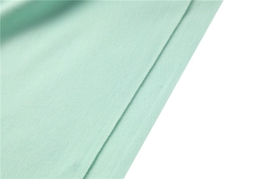 Detailed close-up of mint green twill weave cashmere-like scarf with smooth texture